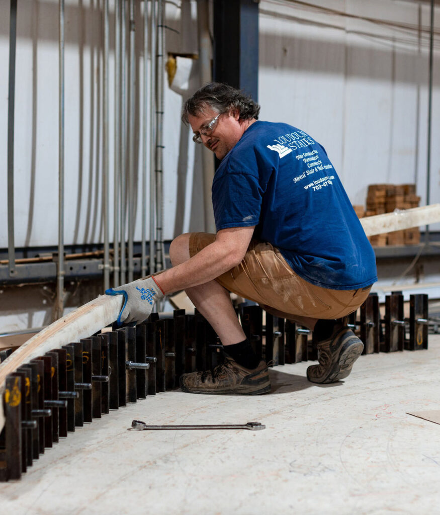 This is a loudoun stairs employee working on building a set of stairs. 