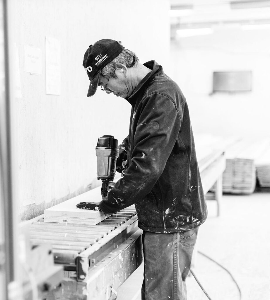 This shows a loudoun stairs factory worker hand building stairs.