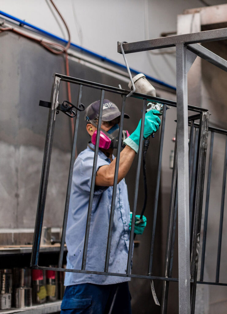 This is a loudoun stairs factory worker hand treating a metal rail in the loudoun stairs factory.