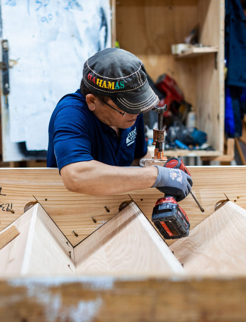 This is a loudoun stairs employee working on building a set of stairs. 